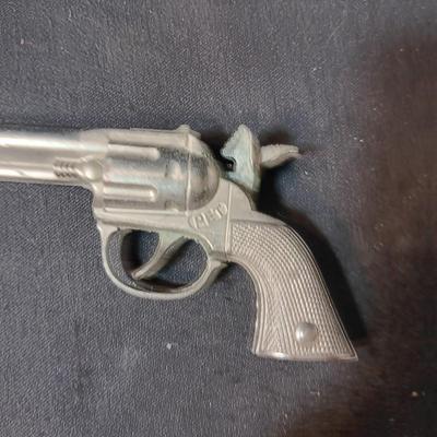 PET TOY CAP GUN WITH A BOX OF ROLLED CAPS AND A SMALLER METAL TOY GUN