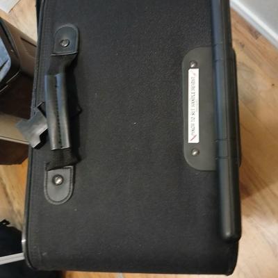 Two suitcases, and several small bags -