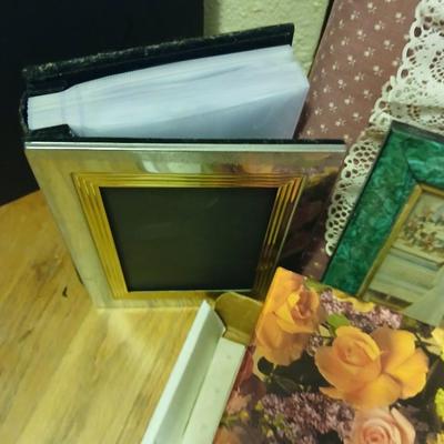 Picture frames of different sizes, and materials - with a large, quilted photo album