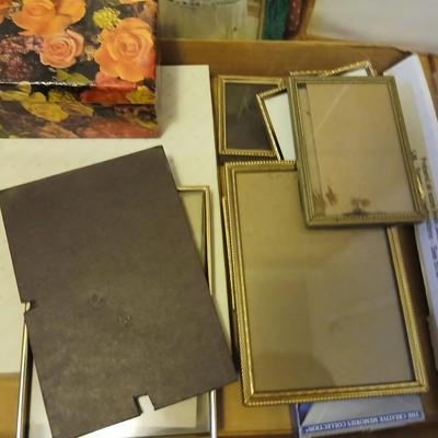 Picture frames of different sizes, and materials - with a large, quilted photo album