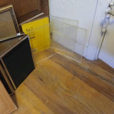 Picture frames of different sizes, and materials - with a large, quilted photo album