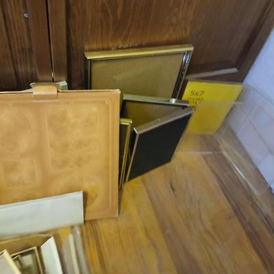 Picture frames of different sizes, and materials - with a large, quilted photo album