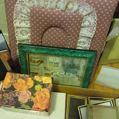 Picture frames of different sizes, and materials - with a large, quilted photo album