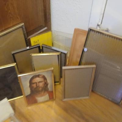 Picture frames of different sizes, and materials - with a large, quilted photo album