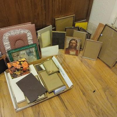 Picture frames of different sizes, and materials - with a large, quilted photo album