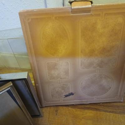 Picture frames of different sizes, and materials - with a large, quilted photo album