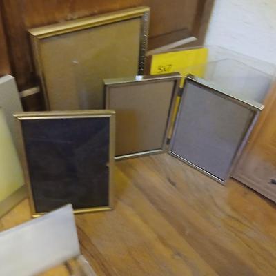 Picture frames of different sizes, and materials - with a large, quilted photo album