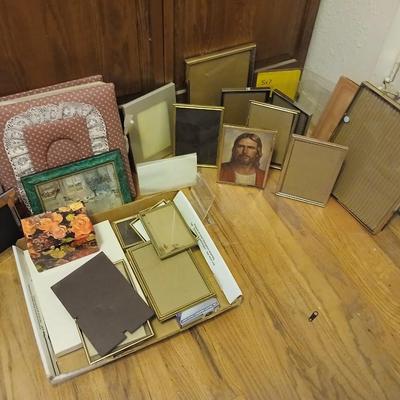 Picture frames of different sizes, and materials - with a large, quilted photo album