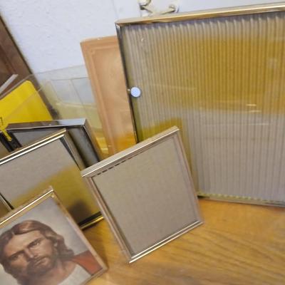 Picture frames of different sizes, and materials - with a large, quilted photo album
