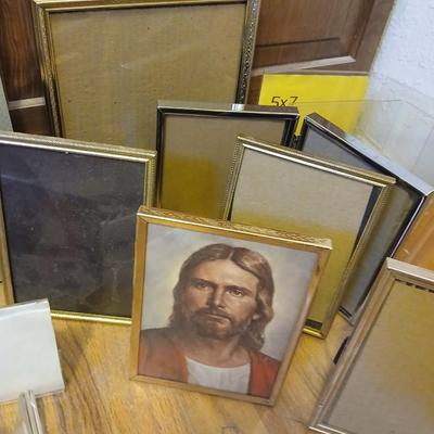 Picture frames of different sizes, and materials - with a large, quilted photo album