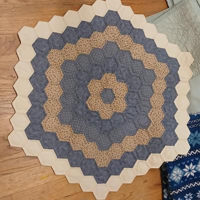 Twin sized bedspread with pillowcases with a Soft Twin blue blanket, a decorative pattern throw, and a quilted Doiley