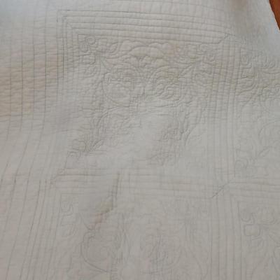 Twin sized bedspread with pillowcases with a Soft Twin blue blanket, a decorative pattern throw, and a quilted Doiley