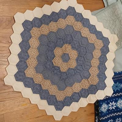 Twin sized bedspread with pillowcases with a Soft Twin blue blanket, a decorative pattern throw, and a quilted Doiley