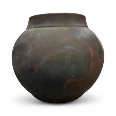 Sale Photo Thumbnail #77: Tony Evans (1942-2009) Raku Pottery Vase.  His Raku pottery features a distinctive volcanic surface and earthy tones and glossy interior drip glaze.
Approximately 14" wideX13" Tall  Opening 7.5"