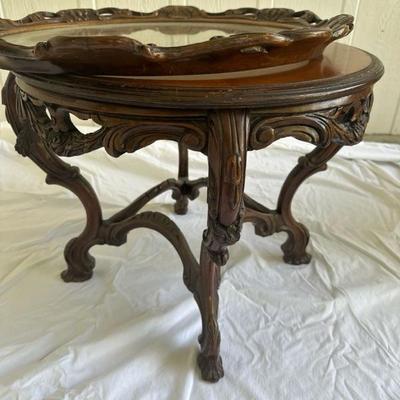 Sale Photo Thumbnail #17: Beautiful Victorian style hand carved coffee table. With wood inlay. And removable glass and wood top 26 inches in diameter and 20 inches tall.