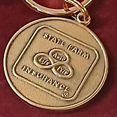 Assortment of award pins with a black fabric covered box