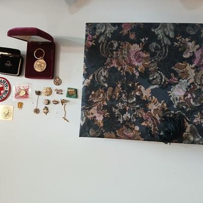 Assortment of award pins with a black fabric covered box