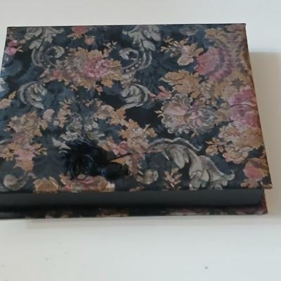 Assortment of award pins with a black fabric covered box
