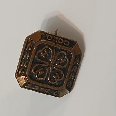 Assortment of award pins with a black fabric covered box