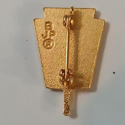 Assortment of award pins with a black fabric covered box