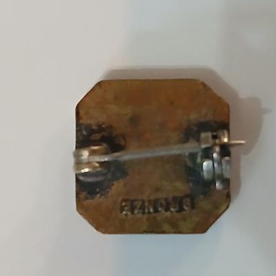 Assortment of award pins with a black fabric covered box