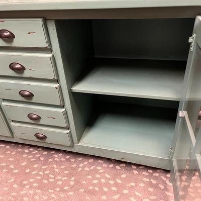 Sale Photo Thumbnail #161: Teal Buffet/Console Cabinet with Dual Glass Doors and Three Center Mounted Drawers.  Does Not Include item on top of the cabinet
62"X18"X35"