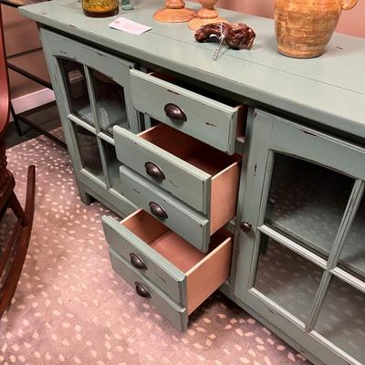 Sale Photo Thumbnail #162: Teal Buffet/Console Cabinet with Dual Glass Doors and Three Center Mounted Drawers.  Does Not Include item on top of the cabinet
62"X18"X35"