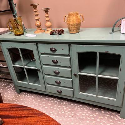 Sale Photo Thumbnail #163: Teal Buffet/Console Cabinet with Dual Glass Doors and Three Center Mounted Drawers.  Does Not Include item on top of the cabinet
62"X18"X35"