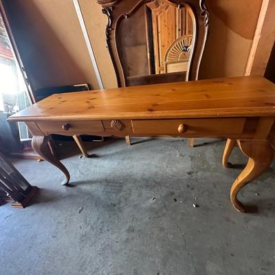 Sale Photo Thumbnail #7: Charming vintage pine table with Queen Anne–inspired cabriole legs and a simple rectangular top. Features two drawers with wooden knobs and a central carved shell motif, offering both function and decorative appeal. Versatile as a writing desk, sofa tab