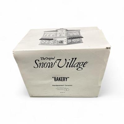 Sale Photo Thumbnail #305: Dept 56 Original Snow Village Bakery 5077-6.  Includes Box, Styrofoam Packer, Light Cord.  Excellent condition, no chips or scratches
Approximately 8.5" H X 6.5" W