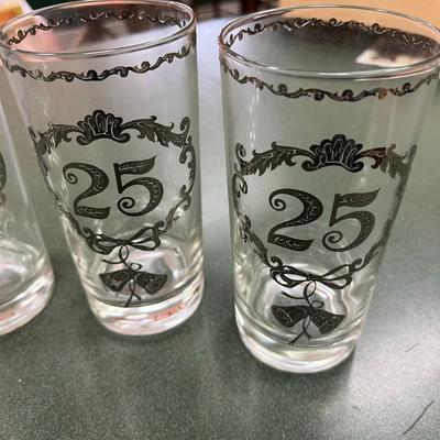 Sale Photo Thumbnail #346: Vintage Culver 25th Anniversary Glasses Set of 8.  These glasses, typically highball or tumbler style, feature decorative silver overlay patterns commemorating a 25th anniversary.  No Chips