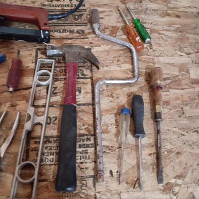 AN ASSORTMENT OF HAND TOOLS AND A POWER STAPLER