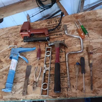 AN ASSORTMENT OF HAND TOOLS AND A POWER STAPLER