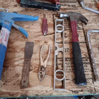 AN ASSORTMENT OF HAND TOOLS AND A POWER STAPLER