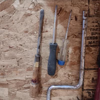 AN ASSORTMENT OF HAND TOOLS AND A POWER STAPLER