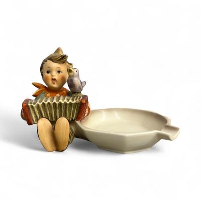 Sale Photo Thumbnail #395: Goebel Hummel Let's Sing Ashtray or Trinket dish #114   Boy Playing an accordion and a bird  Chip on the rear on the coat