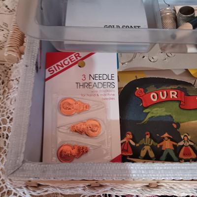SEWING BASKET W/NOTIONS AND A VARIETY OF DOILIES