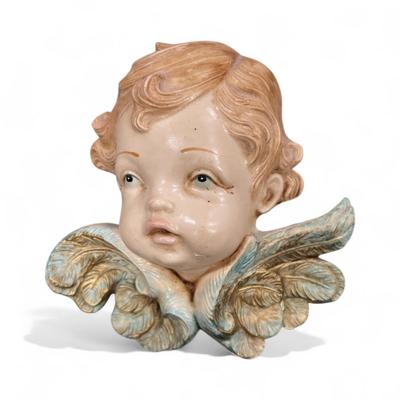 Sale Photo Thumbnail #497: Fontanini Cherub Head Wall Plaque.  These cherub figures are handcrafted in Italy by the Fontanini Company, know for their traditional Lucchesi Figurine designs.  Has a felt pad attached to the back.  No chips or cracks.
Approximately 4" wide and 3.5" tal