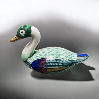 Sale Photo Thumbnail #501: Manifattura Artistica Le Porcellane Swan Figurine from Italy.  These ceramic figurines often featur vibrant colors and intricate details like the fishnet pattern seen on the body of the swan.