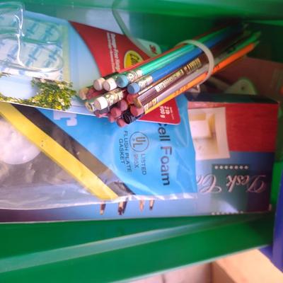 COLORFUL PLASTIC DRAWERS FILLED WITH HOUSEHOLD ITEMS