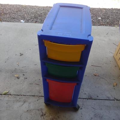 COLORFUL PLASTIC DRAWERS FILLED WITH HOUSEHOLD ITEMS