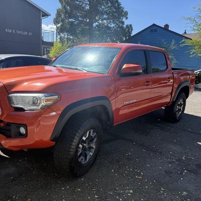 Sale Photo Thumbnail #2: 2023 Toyota Tacoma TRD Off-Road – Rugged, reliable, and adventure-ready! This eye-catching red Tacoma comes with off-road wheels, all-terrain tires, and Toyota’s proven TRD Off-Road package. It has some light cosmetic wear (clear coat on mirrors and a