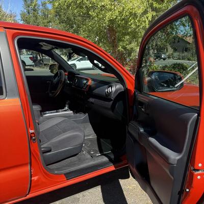 Sale Photo Thumbnail #6: 2023 Toyota Tacoma TRD Off-Road – Rugged, reliable, and adventure-ready! This eye-catching red Tacoma comes with off-road wheels, all-terrain tires, and Toyota’s proven TRD Off-Road package. It has some light cosmetic wear (clear coat on mirrors and a