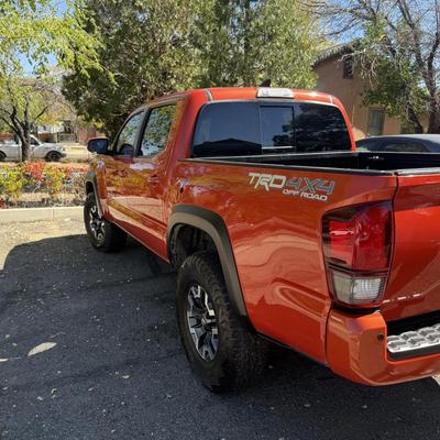 Sale Photo Thumbnail #4: 2023 Toyota Tacoma TRD Off-Road – Rugged, reliable, and adventure-ready! This eye-catching red Tacoma comes with off-road wheels, all-terrain tires, and Toyota’s proven TRD Off-Road package. It has some light cosmetic wear (clear coat on mirrors and a