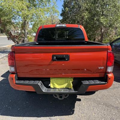 Sale Photo Thumbnail #3: 2023 Toyota Tacoma TRD Off-Road – Rugged, reliable, and adventure-ready! This eye-catching red Tacoma comes with off-road wheels, all-terrain tires, and Toyota’s proven TRD Off-Road package. It has some light cosmetic wear (clear coat on mirrors and a
