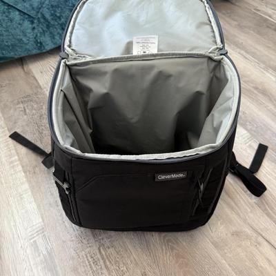 Sale Photo Thumbnail #30: Black insulated cooler backpack, perfect for travel or picnics.