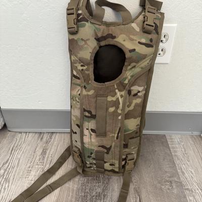 Sale Photo Thumbnail #35: Heavy-duty AKmax Outdoor rucksack system in multicam pattern with multiple attachments. Includes large framed rucksack, hydration carrier, detachable utility pouch, padded hip belt, and additional modular pieces. Built for rugged use, camping, hiking, or 
