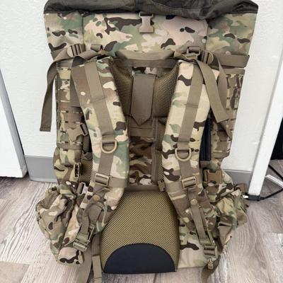 Sale Photo Thumbnail #34: Heavy-duty AKmax Outdoor rucksack system in multicam pattern with multiple attachments. Includes large framed rucksack, hydration carrier, detachable utility pouch, padded hip belt, and additional modular pieces. Built for rugged use, camping, hiking, or 