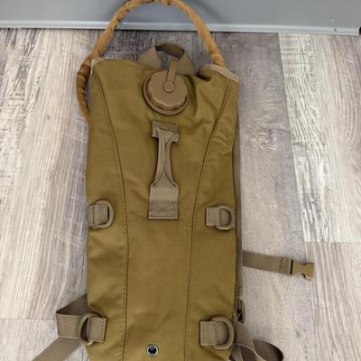 Sale Photo Thumbnail #42: Olive green hydration backpack with bite-tube slot, ideal for hiking, camping, or tactical use.