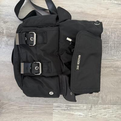 Sale Photo Thumbnail #45: Black nylon backpack with buckle straps and multiple pockets, durable for daily use.